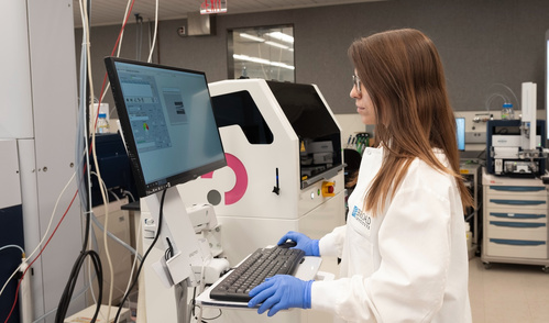 Claudia Ctortecka working with lab equipment.