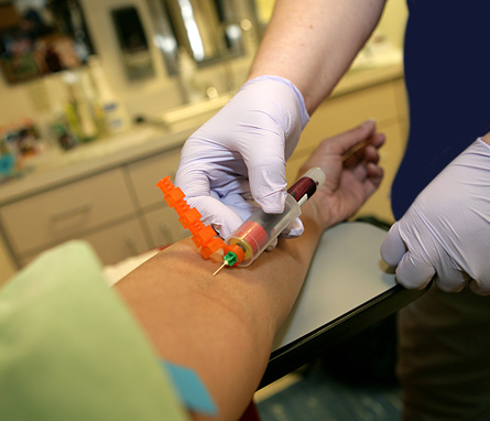 A patient is getting their blood drawn