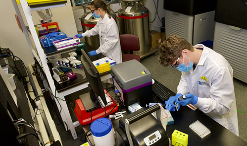 Catie Ramnarine (left) and Ally Day (right) in the Genomics Platform's sequencing lab, which increased the scale and pace of human genome sequencing in 2021.