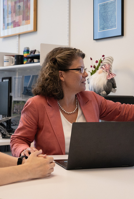 Two scientists look at a computer screen in an office.